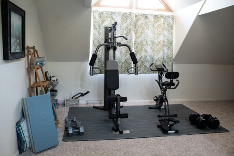 Person performing controlled bodyweight squats beside a workout mat in a bright home space.