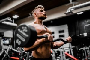 Beginner performing controlled dumbbell exercises in a bright, well-ventilated workout space.