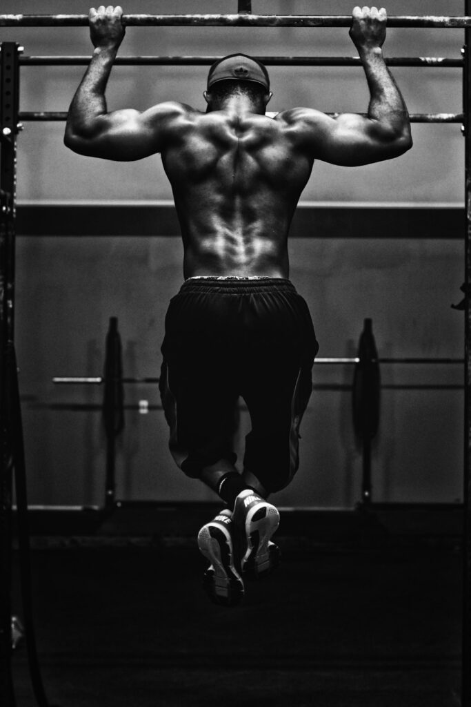 Person performing controlled bodyweight exercises on a mat in a bright, well-ventilated room.